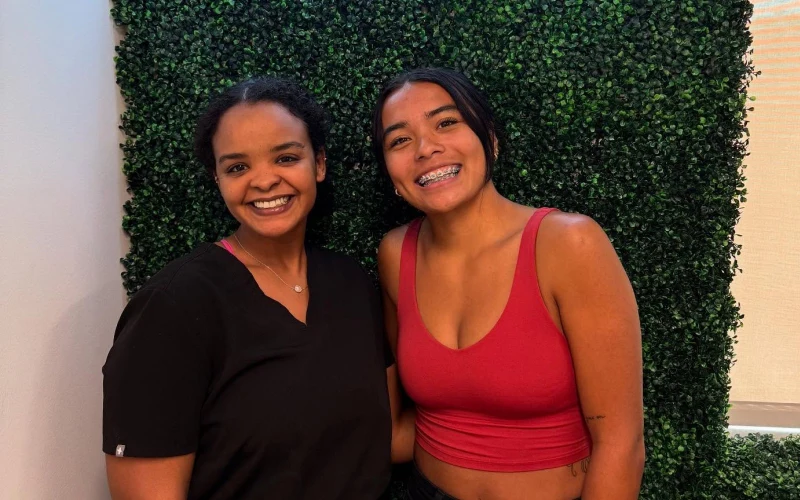 Behl Orthodontics team member with a smiling teen in the office