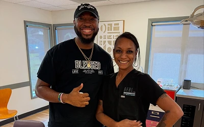 Behl Orthodontics team member chatting with a smiling teen