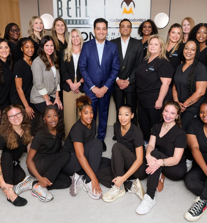 Dr. Yugal Behl smiling with the Behl Orthodontics team
