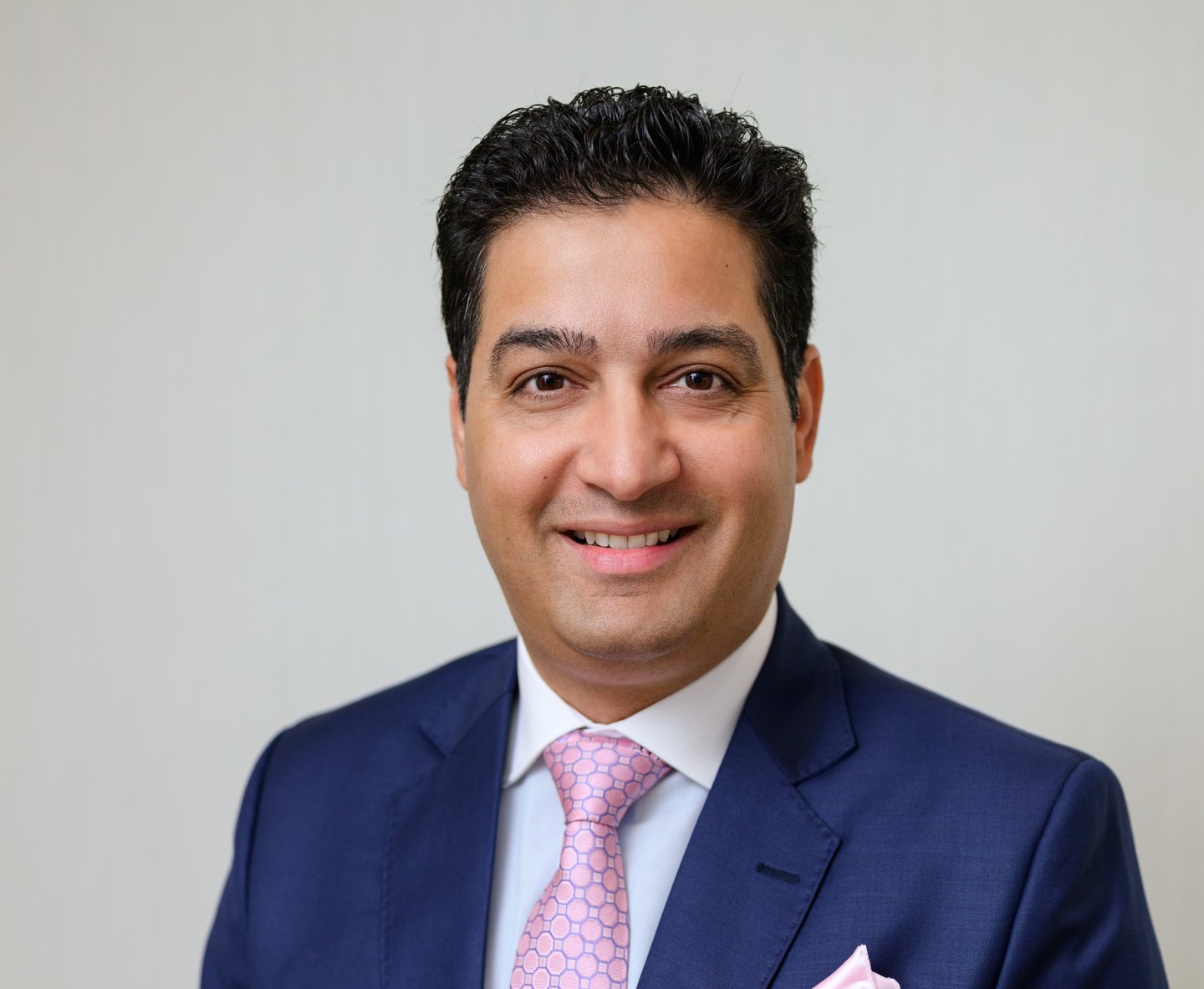 Dr. Yugal Behl smiling in professional attire, showcasing expertise in orthodontics at Behl Orthodontics, Virginia Beach.