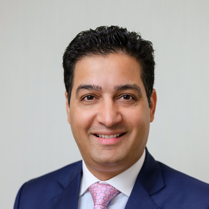 Dr. Yugal Behl smiling in professional attire, board-trained orthodontist at Behl Orthodontics in Virginia Beach.